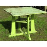 An Arts & Crafts style light green painted and weathered teak garden table, the square slatted
