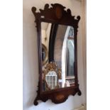 A Georgian mahogany wall mirror with shaped fretted outline, shell and floral inlay detail, 87cm