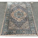 A Middle Eastern design carpet with an apricot central medallion and a floral border, 180cm x