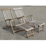 A pair of weathered contemporary teak folding steamer type garden lounge chairs with slatted