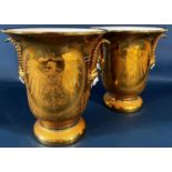 A pair of brush vases in a white and gilt colourway with spread eagle, acanthus, facial mask and