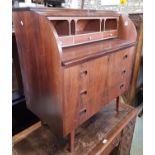 A mid century cylinder top writing bureau, the fitted interior over three drawers on square