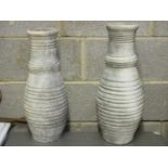 A pair of terracotta baluster shaped ribbed vases, 53cm high