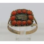 Georgian yellow metal mourning ring containing woven hair within a coral surround, size K/L, 2g