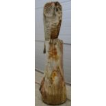 A well weathered carved forest chain saw art study of an owl seated on a stump, 113 cm high