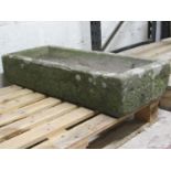 A weathered carved natural stone rectangular trough with dished interior 95 cm long x 38 cm wide x