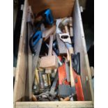 An ex military travelling trunk containing a good selection of hand tools mainly woodworking