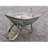 A vintage wheelbarrow with iron spoke wheel