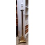 A brass lamp standard in the form of an ionic column on a square cut base