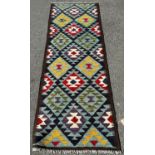 A Maimana Kilim Runner with a large stepped and diamond pattern on a blue ground 212cm x 70cm