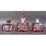 Three matching Czechoslovakian red cut glass dressing table perfume bottles and powder box, cut with