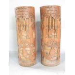 Two Chines bamboo brush pots with carved decoration both 32cm high approx.