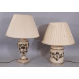 Two lamps white colourway with trailing vine detail, one of cylindrical form and one of vase form (