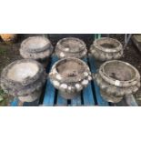 A set/run of six weathered cast composition stone garden urns of circular lobed form 40 cm