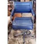 A vintage barbers/hairdressers chair with polished chrome framework and blue upholstery