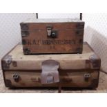 A vintage pine and steel banded tuck box and a further green canvas and leather bounded travelling