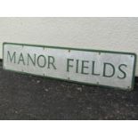 A painted aluminium sign 'Manor Fields' 105cm x 23cm