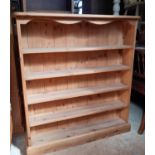 A contemporary pine bookcase of shallow proportions 98 cm high x 90 cm wide x 17 cm deep