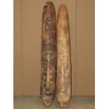 Two similar carved wooden elongated tribal wall masks 102 cm x 15 cm
