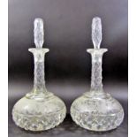 Four matching Victorian cut glass decanters (one stopper missing), and a pair of flat bottomed