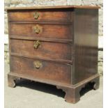 A small Georgian mahogany and oak lined chest of four long graduated drawers raised on bracket