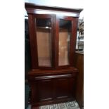 A Victorian mahogany library bookcase, the lower section enclosed by two panelled doors, the upper