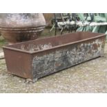 An antique cast iron rectangular trough (cracked) 154 cm long x 50 cm wide x 34 cm high