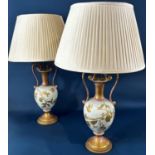 A pair of porcelain vases with drawn necks and scrolled handles adapted as table lamps