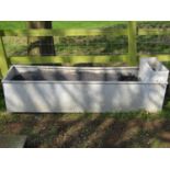 A galvanised steel rectangular field water trough with raised box cistern, (af) 186cm long x 48cm