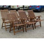 A set of six contemporary folding hardwood garden armchairs with slatted seats and backs