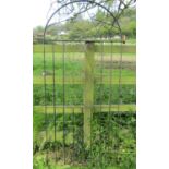 An ironwork arched pedestrian side gate with decorative open scroll detail, 85 cm (full width) x 182