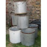Seven weathered galvanised cylindrical tubs with steel bands 45 cm diameter x 46 cm high (one