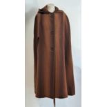 Vintage cape by Welsh Woollens in woven woollen cloth, fully lined with button front and hood.