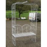 A cream painted light steel sectional garden arbour, with repeating open leaf patterned design and