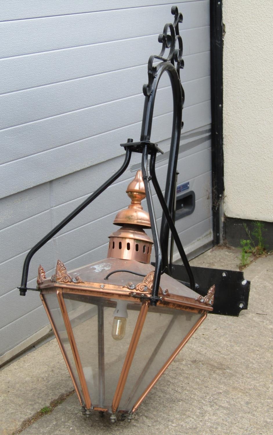 A large Victorian style lantern, the tapered copper hood with perspex panels suspended from a
