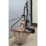 A large Victorian style lantern, the tapered copper hood with perspex panels suspended from a