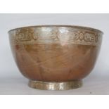 A copper bowl with incised decoration to the rim and foot, 27cm diam.