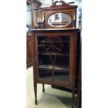 An inlaid Edwardian mahogany music cabinet with glazed panelled door on square tapered legs, 58cm
