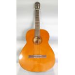 A Rose-Morris Dulcet Classic acoustic guitar Stock No 3057, with a plastic cover and an