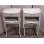 A pair of contemporary bedside tables with shallow frieze drawers on shaped supports with painted
