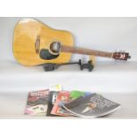 An Encore Acoustic guitar Model No W -265, eight various guitar wall mounts, and a selection of