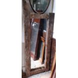 A rustic framed mirror, the pegged oak frame of considerable age, 160cm x 63cm approx