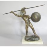 A bronze statue of a Greek Warrior about to throw a spear, raised on a rock set on a marble