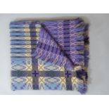 Traditional Welsh blanket in reversible double weave, in mauve, blue black and yellow colours.