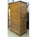 A vintage four drawer filing cabinet with reeded sides, within a panelled framework