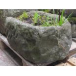 A weathered carved natural stone rectangular trough with rounded end 52 cm long x 38 cm wide x 25 cm