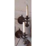 A pair of cast brass wall lights in the form of marine candlesticks, gimble mounted