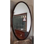 A simple oval wall mirror with beaded border and bevelled edge plate, 69cm max