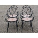 A set of four heavy gauge painted steel garden open armchairs with S shaped scroll detail and