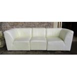 A contemporary stitched cream leather upholstered three sectional sofa and matching rectangular